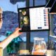 Chef using a tablet to manage kitchen orders in a restaurant setting.